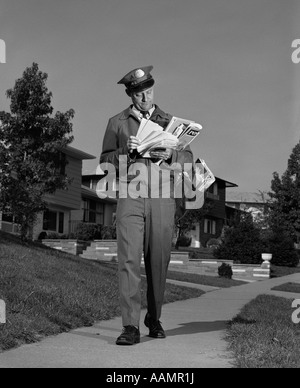 1960s MAN MAILMAN DELIVERING MAIL TO WOMAN HOUSEWIFE IN FRONT OF St