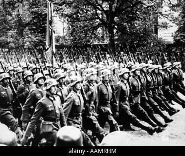 1940s GERMAN TROOPS MARCHING GOOSE STEPPING IN STREETS OF WARSAW POLAND 1941 Stock Photo