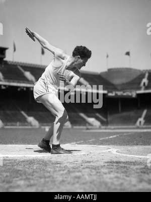 1930s BOY TRACK AND FIELD ATHLETE GETTING READY TO THROW A DISCUS Stock Photo