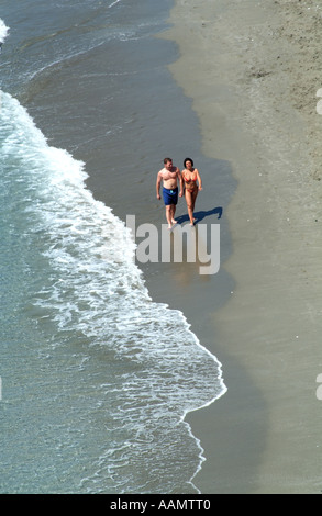 Young couple walking on the beach at Nerja in southern Spain Europe EU. Stock Photo