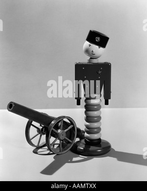 1930s WOODEN TOY SOLDIER NEXT TO CANNON Stock Photo