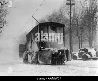 1930s 1940s SPECIAL TROLLEY CAR BRUSHING SNOW OFF TRACKS ON CITY STREET IN WINTER PHILADELPHIA PENNSYLVANIA USA Stock Photo