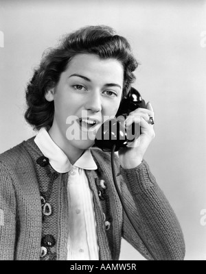 1940s 1950s YOUNG WOMAN TALKING ON TELEPHONE Stock Photo