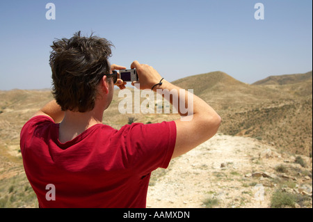 male canadian tourist taking a photo of the desert at matmata tunisia Stock Photo