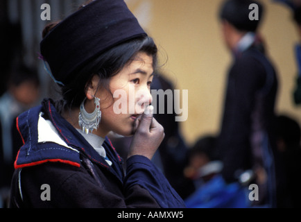 Pretty Black Hmong ethnic minority girl warming hand, Sapa, Tonkinese Alps, North Vietnam Stock Photo