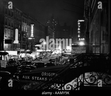1940s NIGHT STREET SCENE NEW YORK CITY WEST 52nd STREET LIGHTS FROM NUMEROUS CLUBS AND NIGHTCLUBS Stock Photo