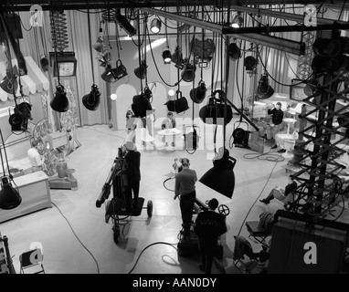 1960s BEHIND-THE-SCENES FILMING OF TV TALK SHOW IN STUDIO WITH SEVERAL LIGHT FIXTURES AND MONITORS HANGING FROM CEILING Stock Photo