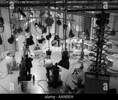 1960s PARTIAL OVERHEAD FROM BEHIND SCENES OF TELEVISION STATION FILMING TALK SHOW Stock Photo