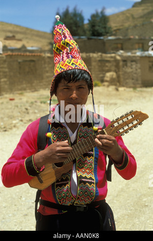 An Indian man wearing traditional clothes plays the charango in  Cochabamba Department the Bolivian Andes Stock Photo