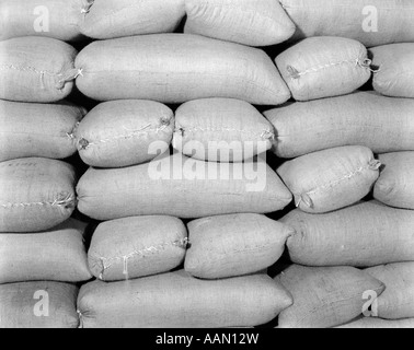 1920s 1930s 1940s PILE OF BURLAP SACKS IN OVERALL PATTERN Stock Photo