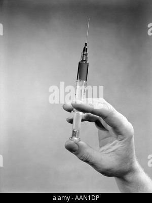 1930s 1940s 1950s HANDS PREPARING DRUG SHOT INJECTION SYRINGE Stock ...