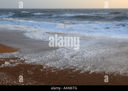 Incoming tide at Burton Bradstock in December 2006 Stock Photo