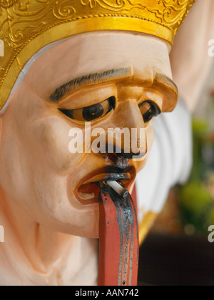 Smoking statue in Hong San See Chinese Temple in Singapore Stock Photo