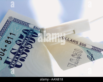 MODEM PHONE CABLE AND FIFTY DOLLAR TRAVELLERS cheque Stock Photo