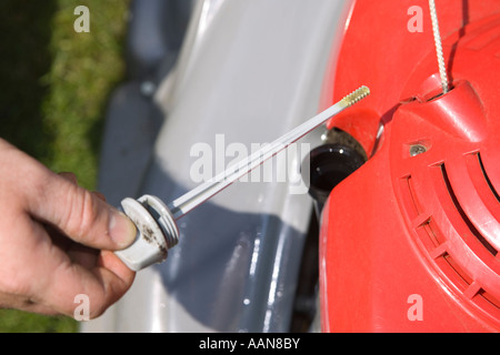 checking oil level in lawnmower engine Stock Photo