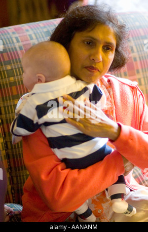 Grandmother (India) holding an infant.  St Paul Minnesota USA Stock Photo