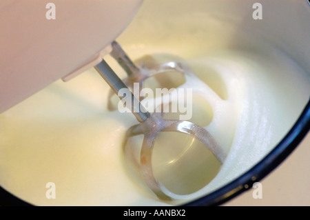 Beaters in a bowl in the process of whipping cream Stock Photo