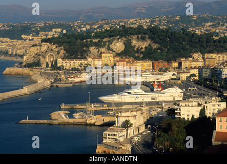 The harbour port at Nice, South of France with large luxury yachts in the harbour - at dusk Stock Photo