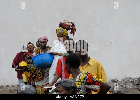 Displaced people queuing for food distribution carried out by the World Food Program WFP in North Kivu province DR Congo central Africa Stock Photo