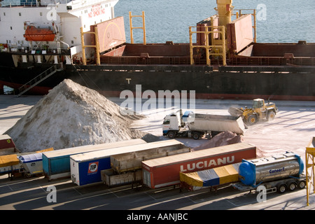 Shipment of salt at Cagliari Dockside, Sardinia, Cagliari Port Sardinia truck lorry ship shipping hold container transport Stock Photo