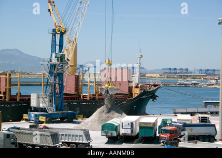 Trucks, Cranes, and Ships , Shipment of salt at Cagliari Harbour, Sardinia, Cagliari Port Sardinia truck lorry harbour harbor Stock Photo