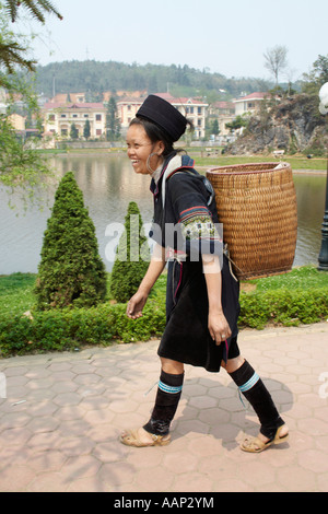 Young woman from the Black Hmong hill tribe on her way to the weekly market in Sapa, Vietnam. Stock Photo