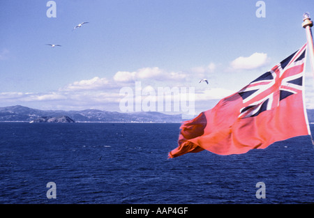 The Red ensign Merchant navy flag on stern of SS Canberra refrigeratiion cargo ship off coast of New Zealand in 1958 Stock Photo