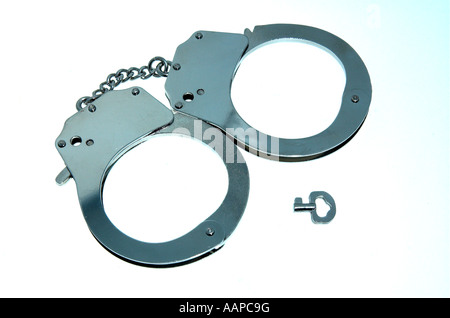 still life of closed shut hand cuffs handcuffs with key Stock Photo