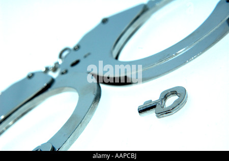 close-up of closed shut hand cuffs handcuffs with key Stock Photo