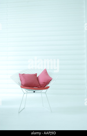 Chair with two pink cushions Stock Photo