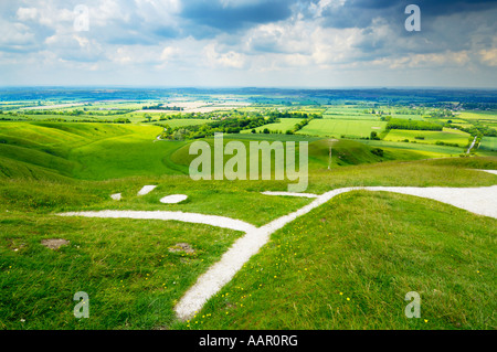 View over the Vale of White Horse, The Manger, Dragon Hill and the Uffington White Horse from Whitehorse Hill in Oxfordshire, England. Stock Photo