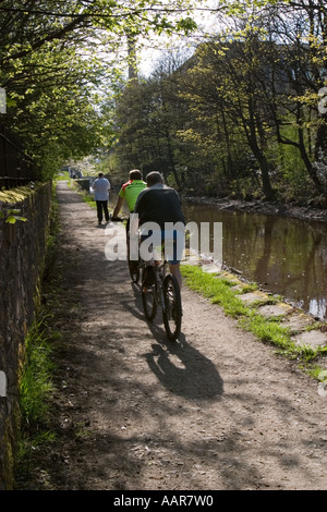 Cyclist on tow path besdie Huddersfield Narrow Canal at Slaithwaite Stock Photo