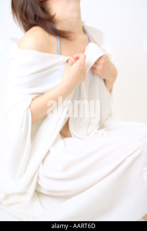 A young woman covering with white sheet Stock Photo