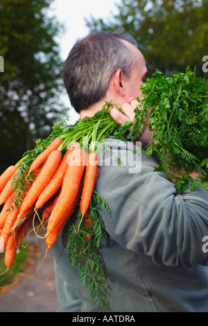 Man with carrots Stock Photo