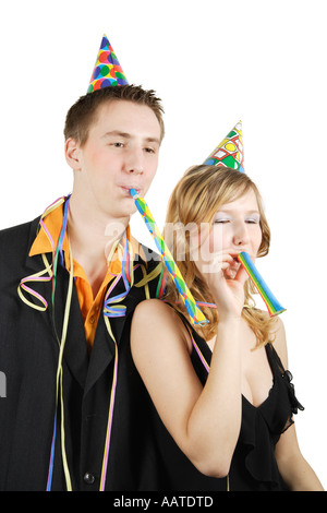 Two young woman blowing noise blower Stock Photo - Alamy