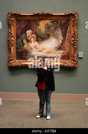 Metropolitan Museum of Art, NYC. Woman standing in front of gold framed painting. Stock Photo