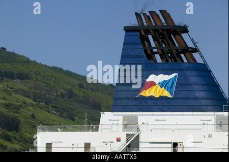 Funnel of P & O ferry Pride of Bilbao seen against Mount Serantes while in port at Santurtzi, Pais Vasco, Spain. Stock Photo