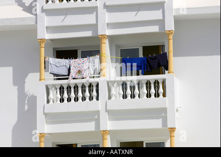 clothes drying in hot summer sun on balconies of tourist hotel rooms in a hotel in hammamet tunisia Stock Photo