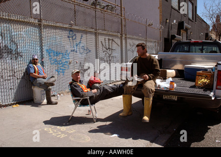 Workmen having lunch break in lower Manhatten. Stock Photo
