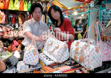 fake designer pirate pirated luxury goods on sale stall petaling street  chinatown kuala lumpur malaysia louis vuitton bags Stock Photo - Alamy