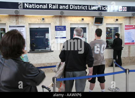 people queuing to buy train tickets Stock Photo