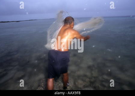 Net Fisherman throwing net in the rain Marshall Islands Stock Photo