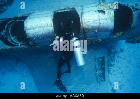 Diver exploring wreck of Douglas Devastator in the Western Pacific at Jaluit Atoll Stock Photo