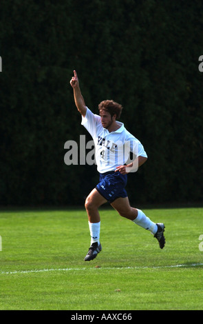 Football soccer player celebrating after scoring goal finger up signifying number one 1 Stock Photo