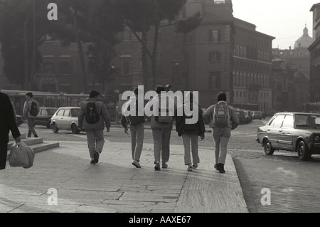 Boys walking along with rucksacks in Rome, Italy. Stock Photo