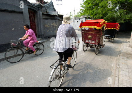 Hutong, Beijing; Typical traffic of bicycles and rickshaws in an old Beijing hutong China 2005 Stock Photo