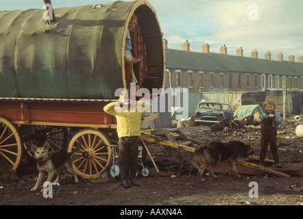 Gypsy camp family mother and two children traditional wooden bow topped caravan parked in waste land central Belfast Northern Ireland  1970s 1970 Stock Photo