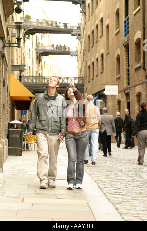 Young couple walking through Butlers Wharf in London Stock Photo