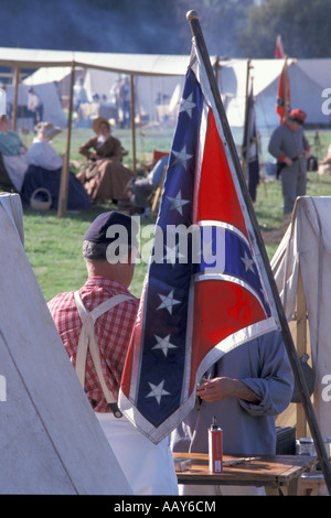 United States confederate flag at historic civil war reenactment with tents and soldiers vertical Stock Photo