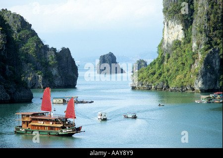 Tourist junk cruise boat with red sails, Halong Bay, Viet Nam Stock Photo